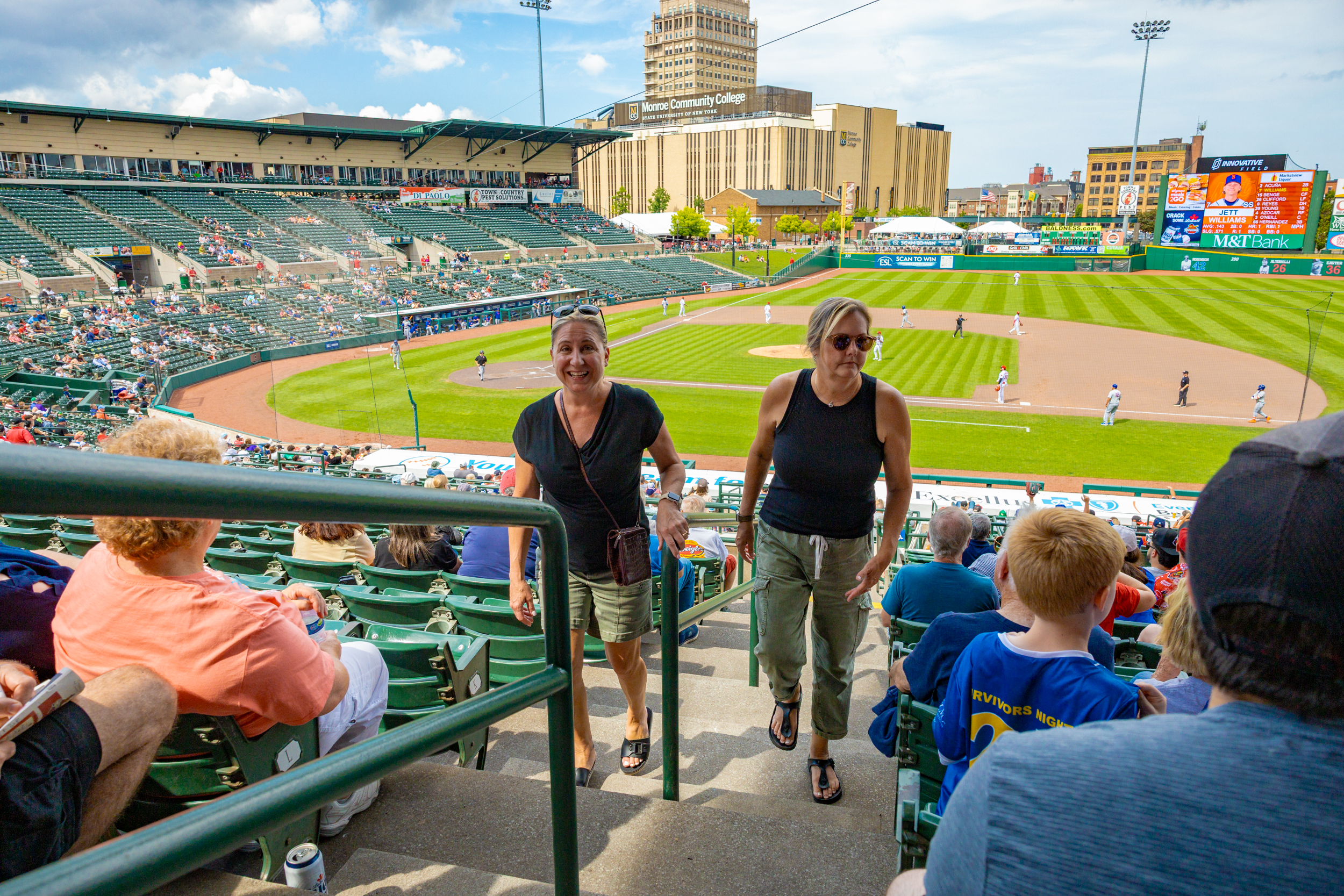 2 girls walking up the steps at a stadium